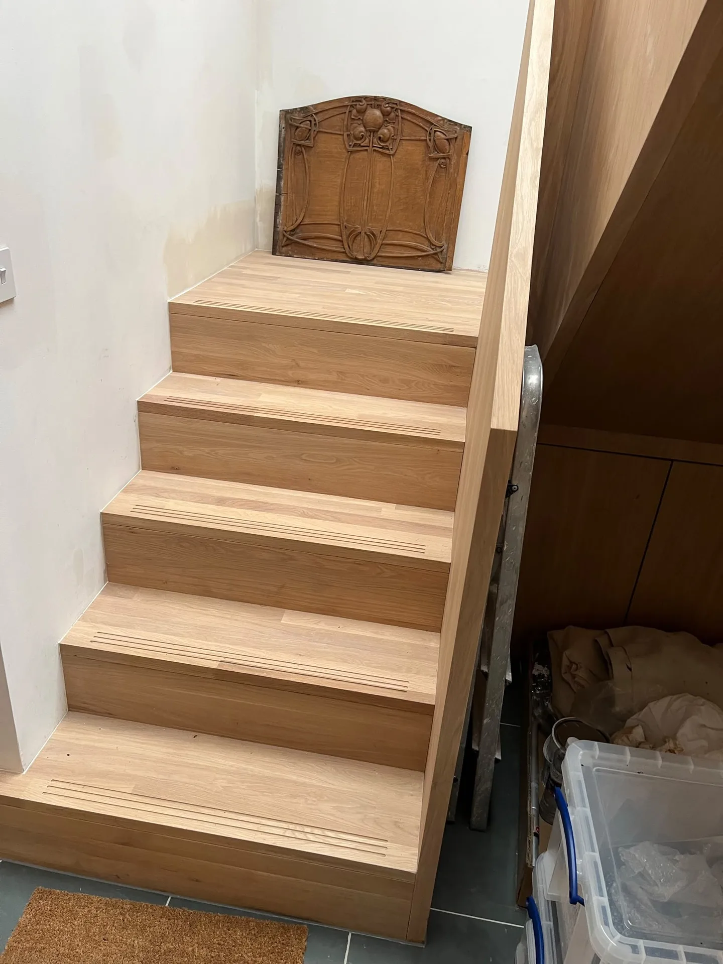 Custom wooden staircase with ornate panel detail