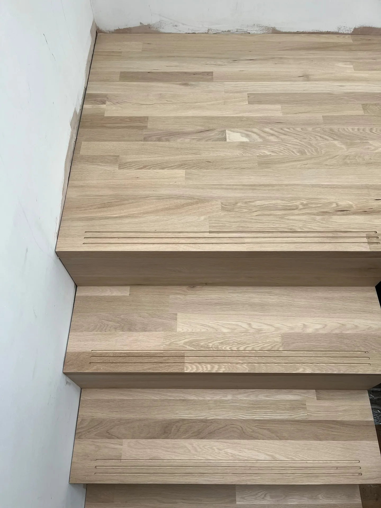 Light oak wooden staircase installation