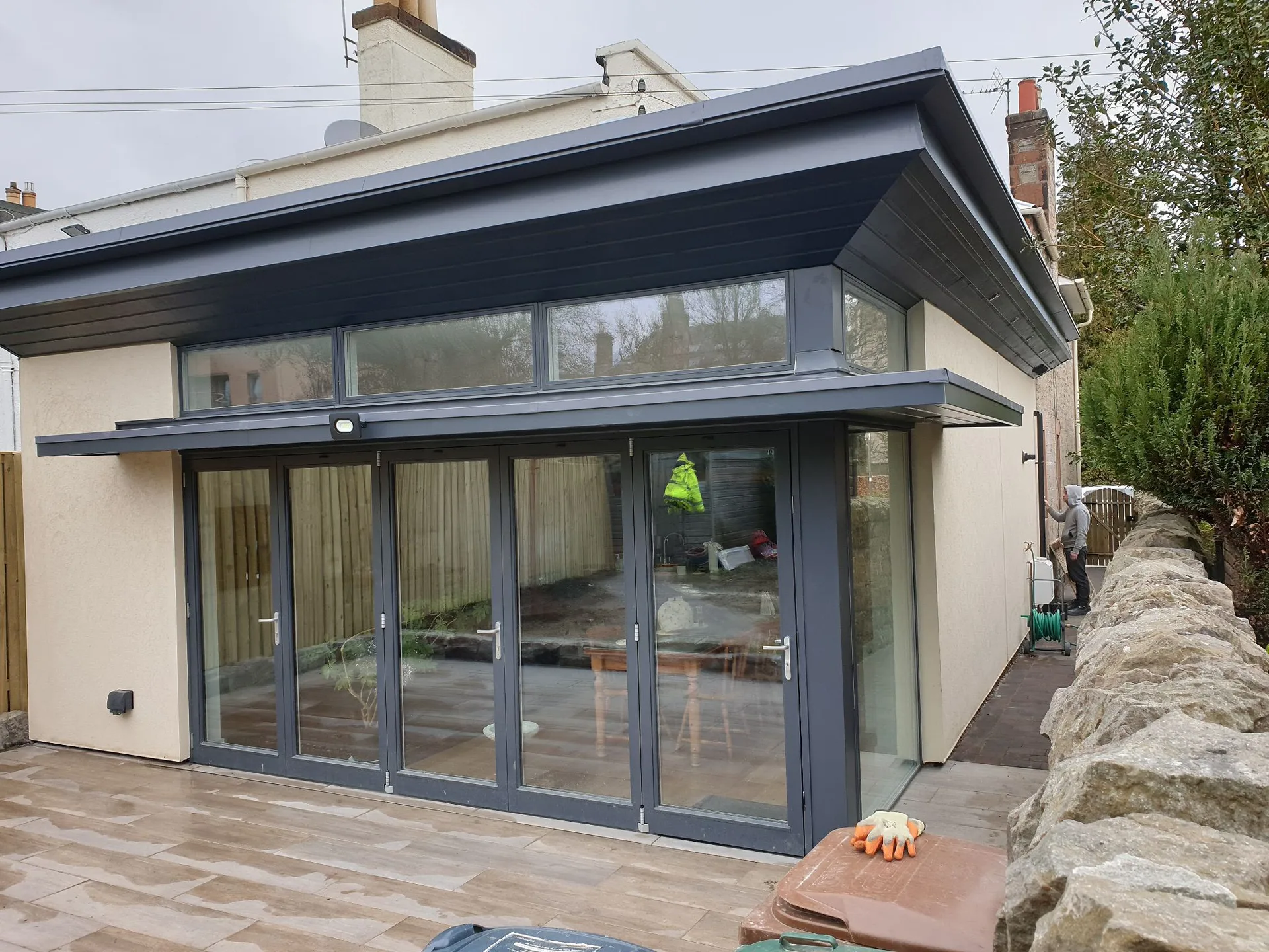 Modern dark-framed glass extension with patio