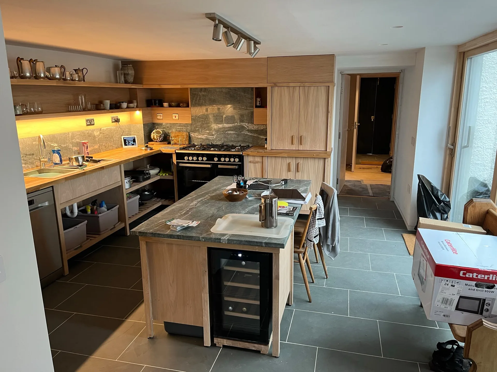 Modern kitchen with light wood cabinetry and island