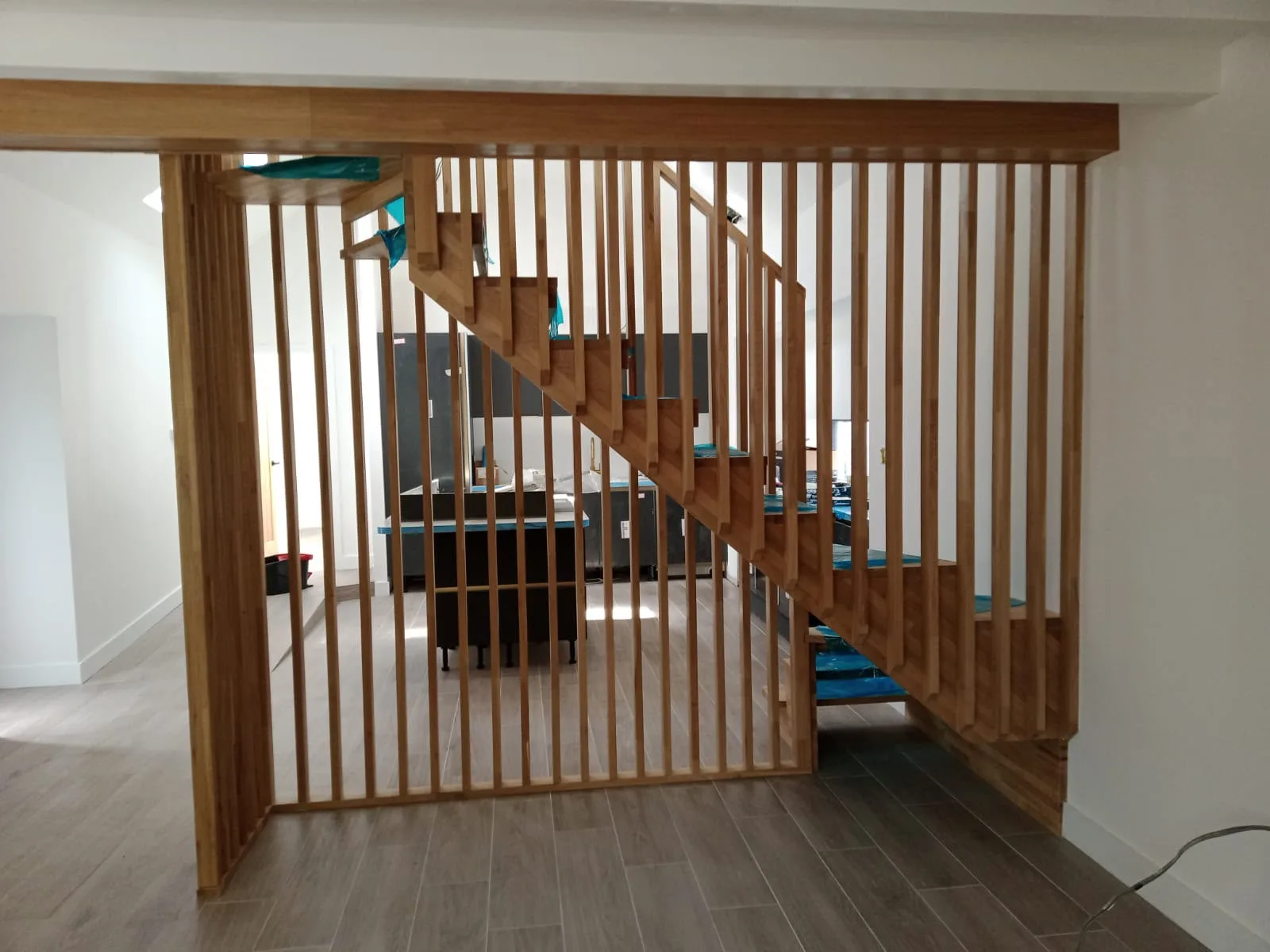 Modern wooden staircase with vertical railings