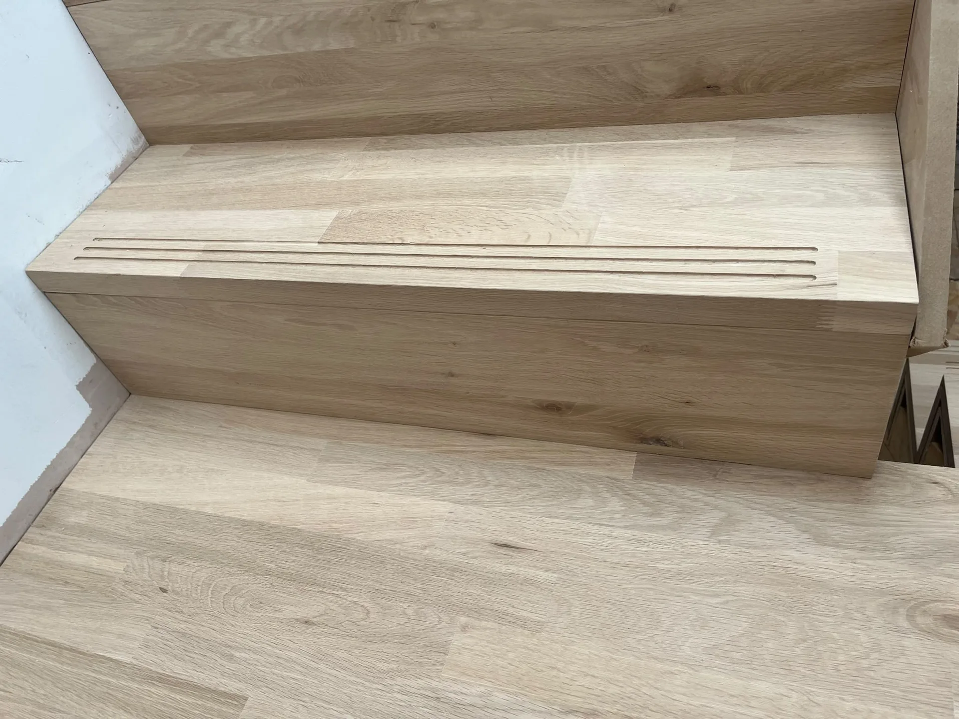 Wooden storage bench with light oak finish