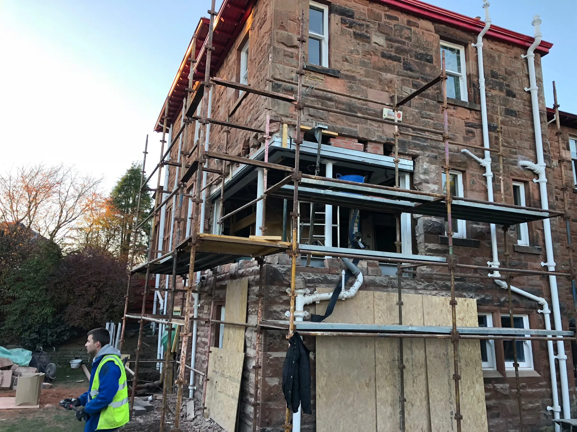 Stone building renovation with metal scaffolding