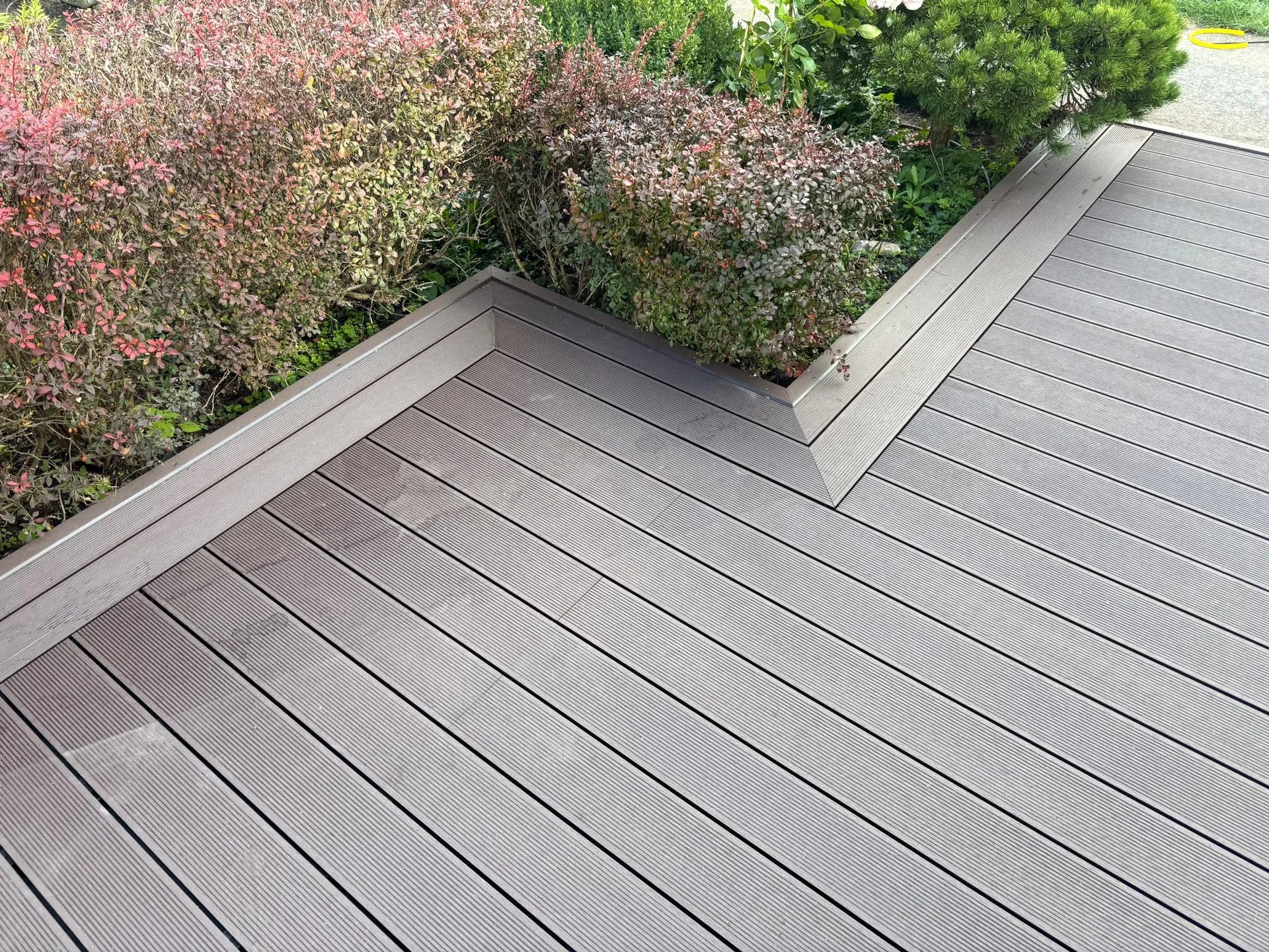 Modern composite deck with flowering garden border