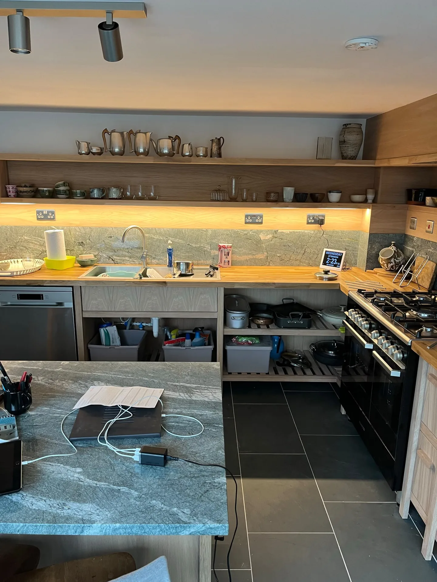 Modern kitchen with golden counters and shelving