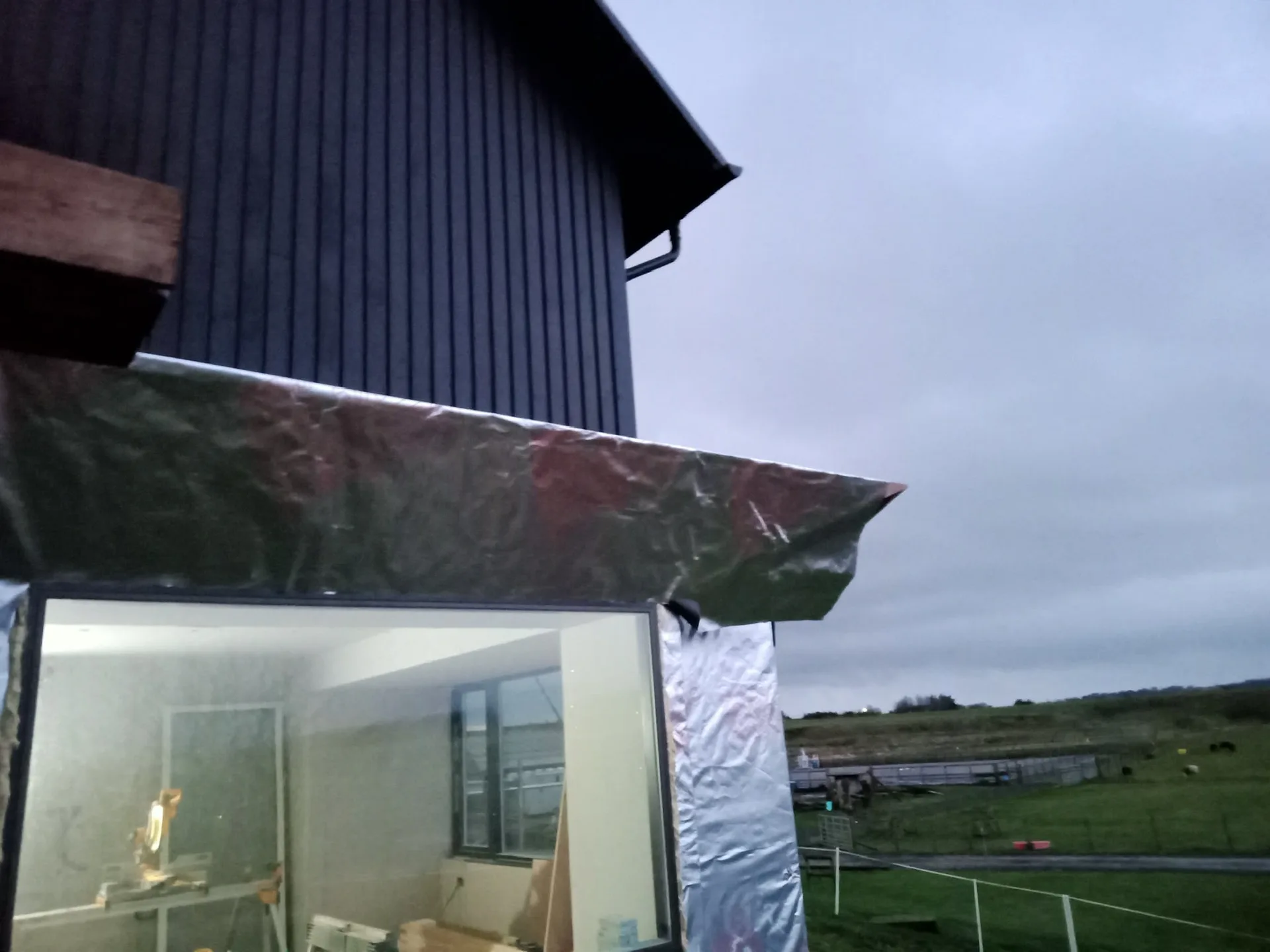 Modern rural building with dark corrugated metal roof