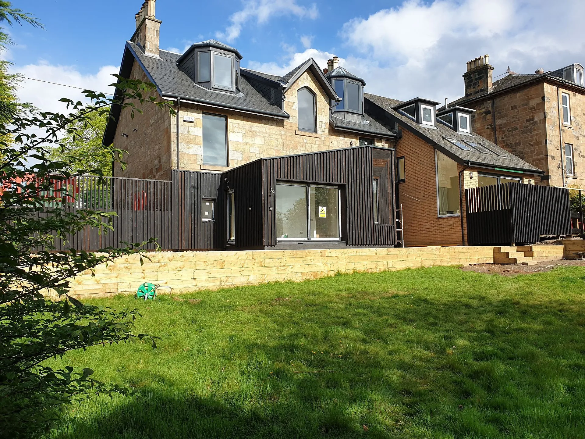 Modern extension to traditional stone house