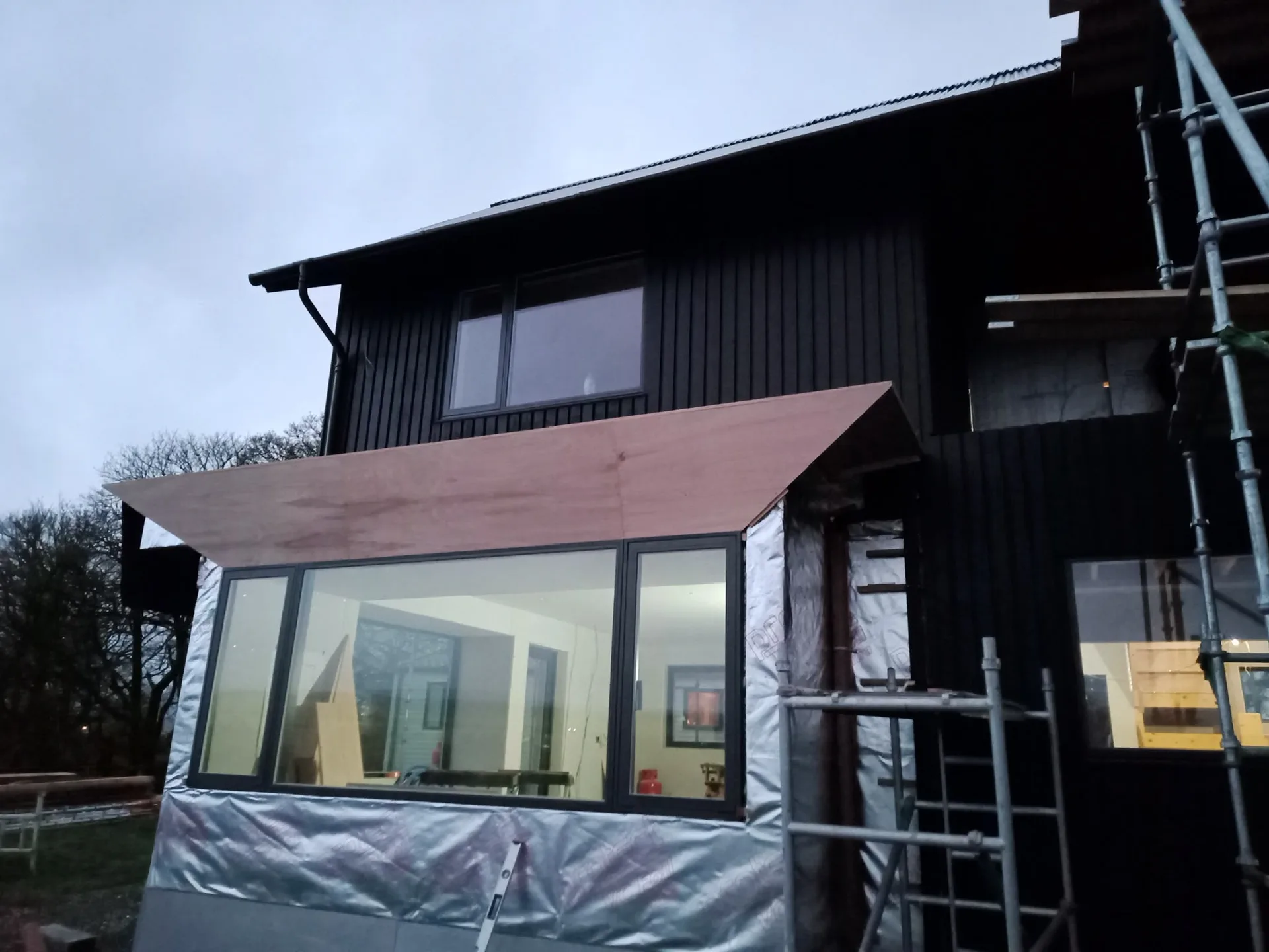 Modern home renovation with black metal cladding