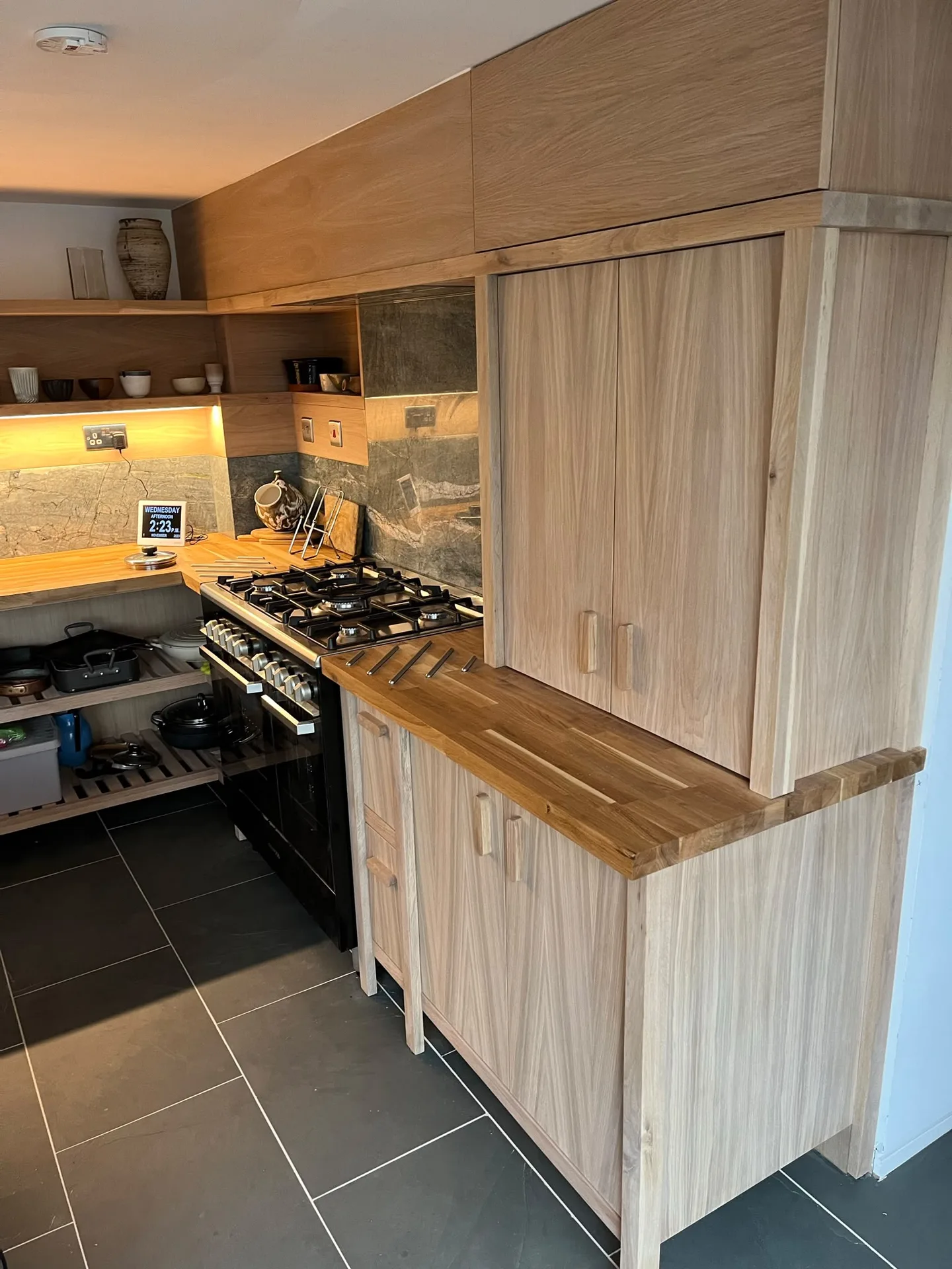 Modern kitchen with light wood cabinetry and counters