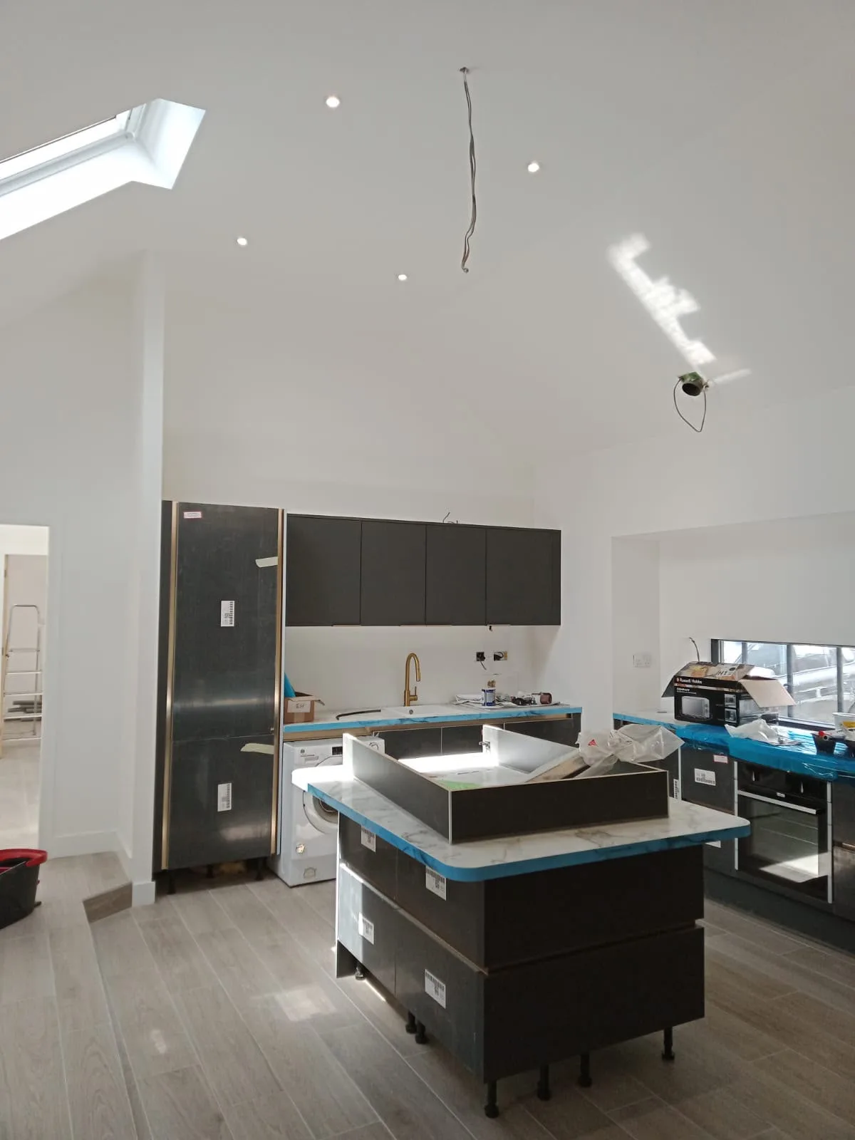 Modern black kitchen with blue countertop