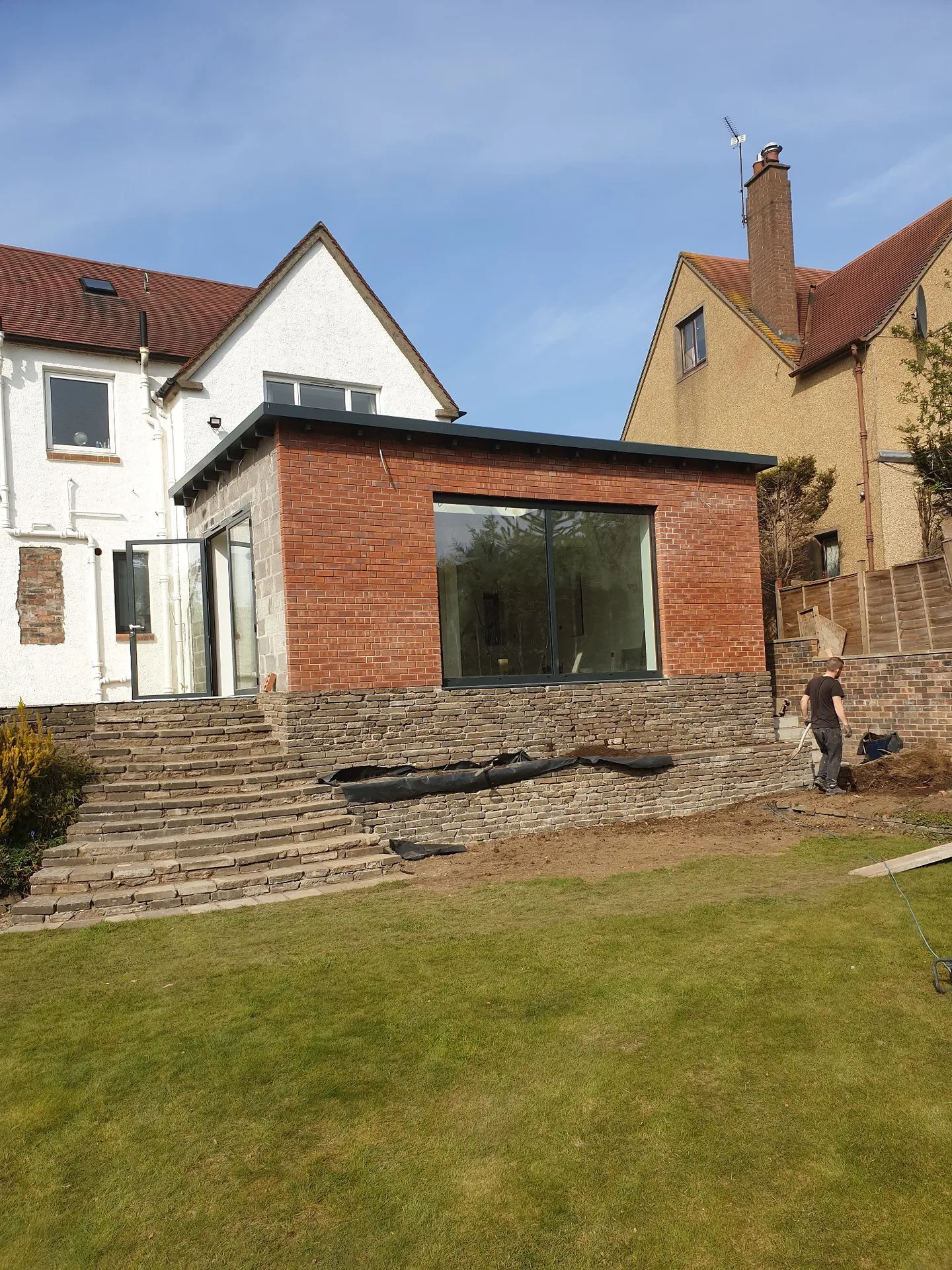 Modern brick house extension with large window