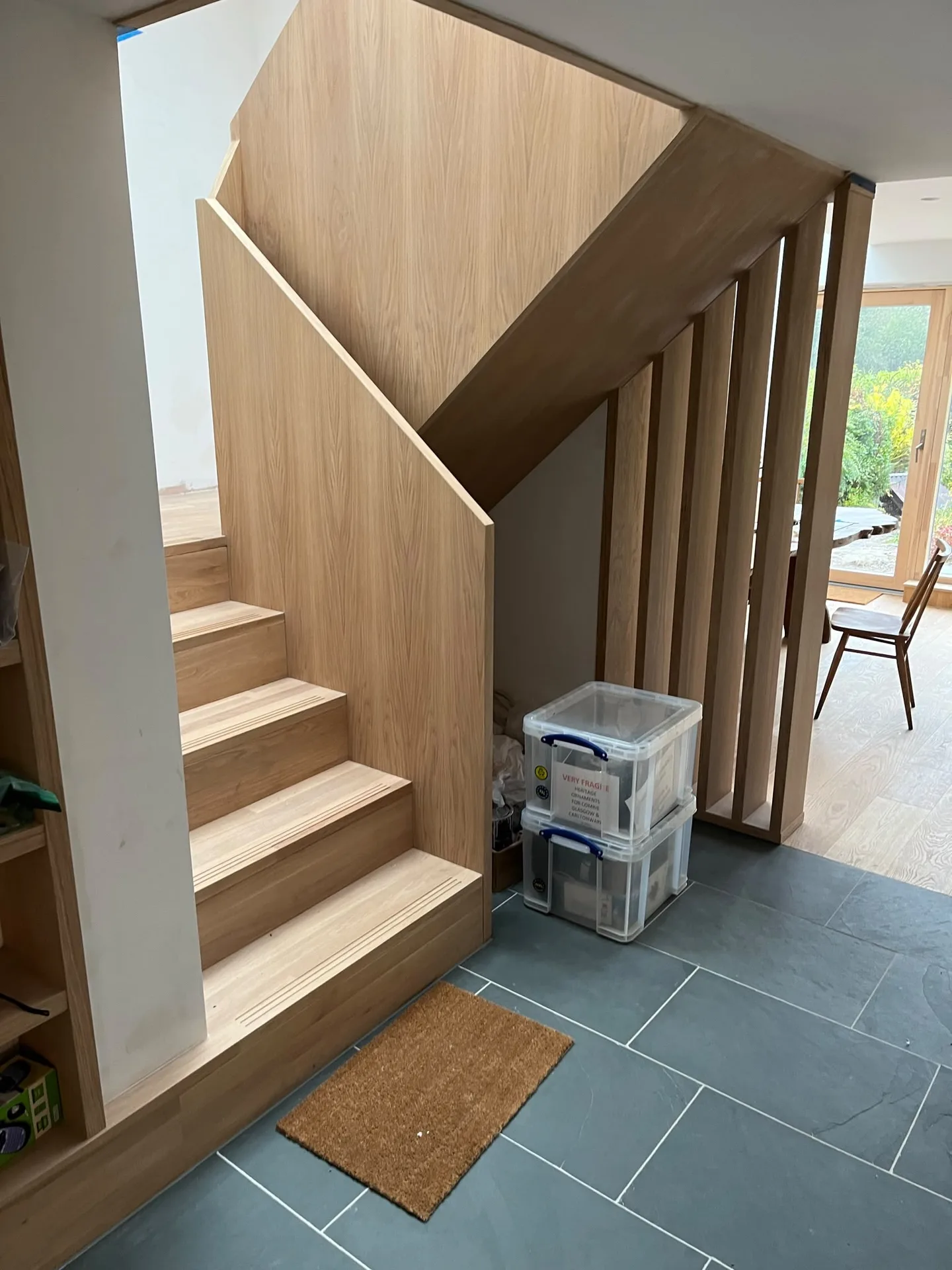 Modern wooden staircase with tile flooring