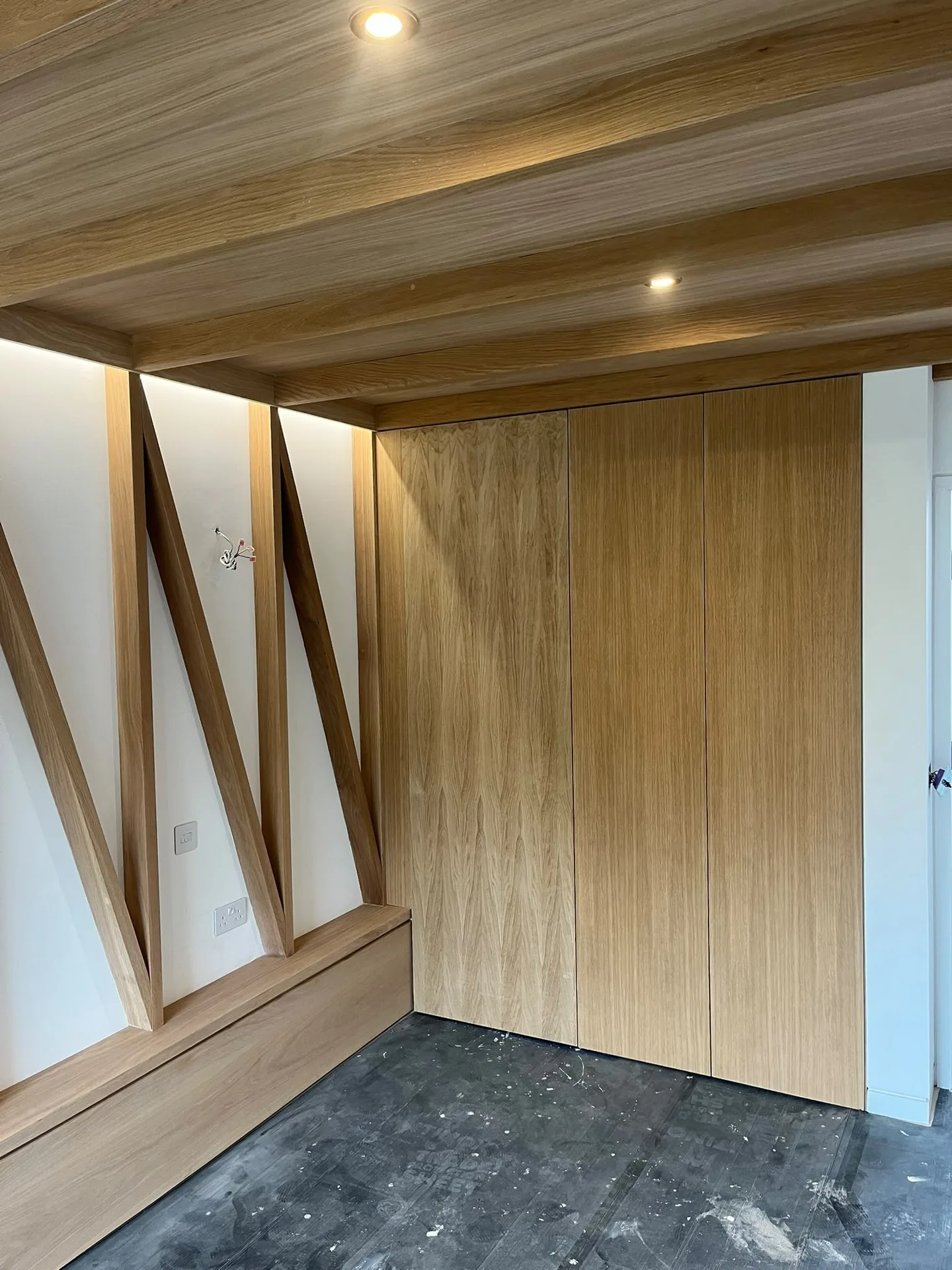 Garage conversion with custom timber panelling, wooden ceiling and recessed lighting