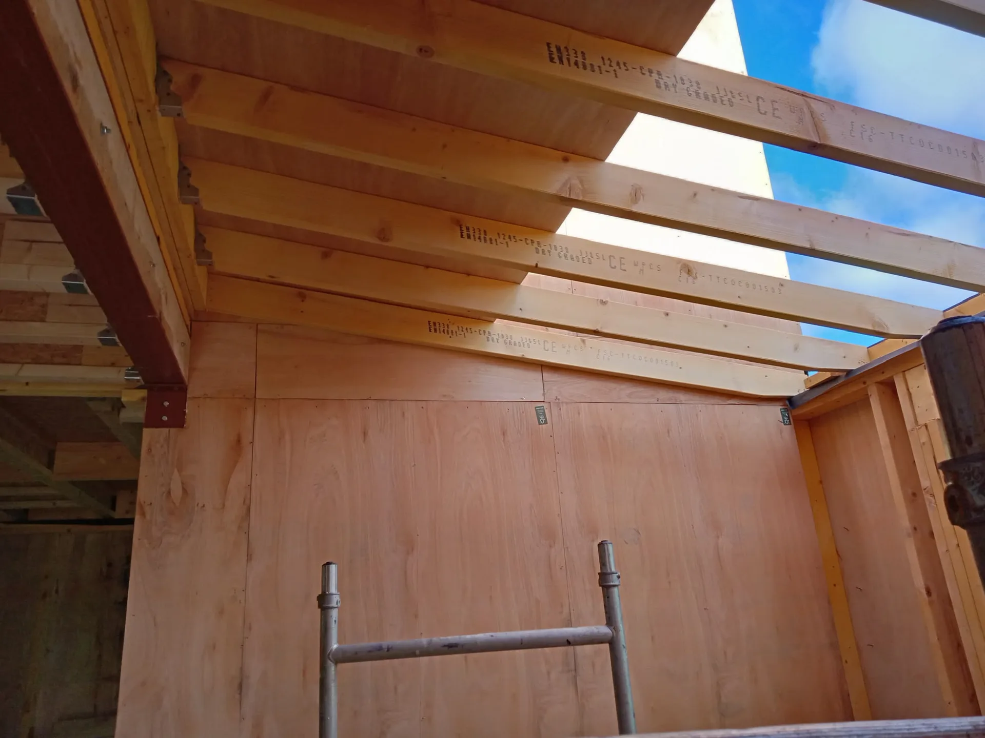Wooden loft conversion roof frame with openings for dormer windows under construction
