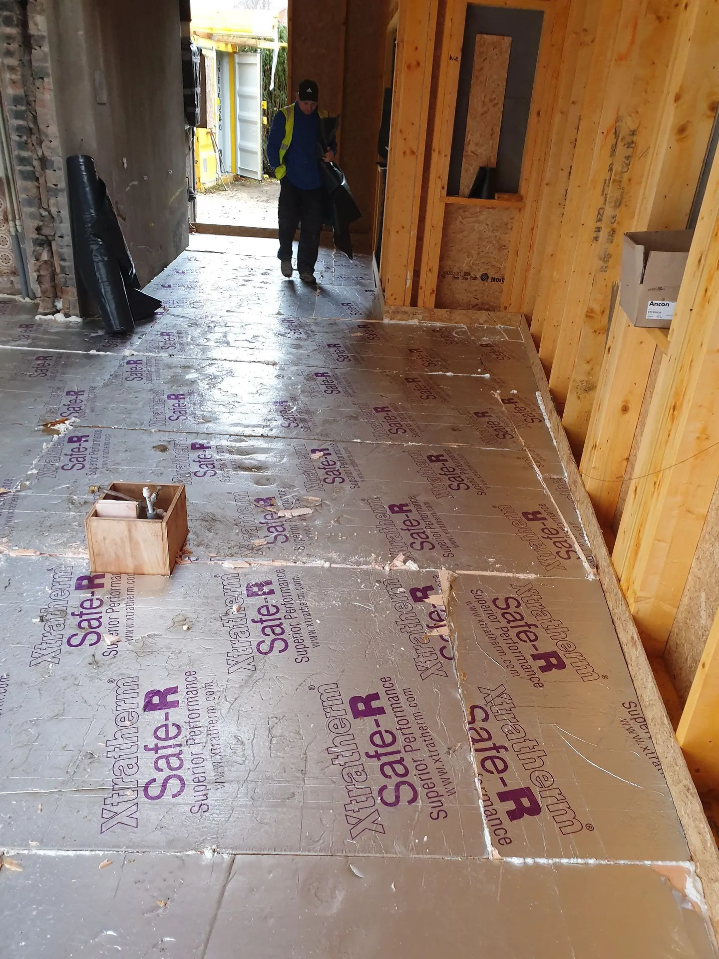 Construction site interior with wooden wall framing and thermal insulation floor protection during house renovation works