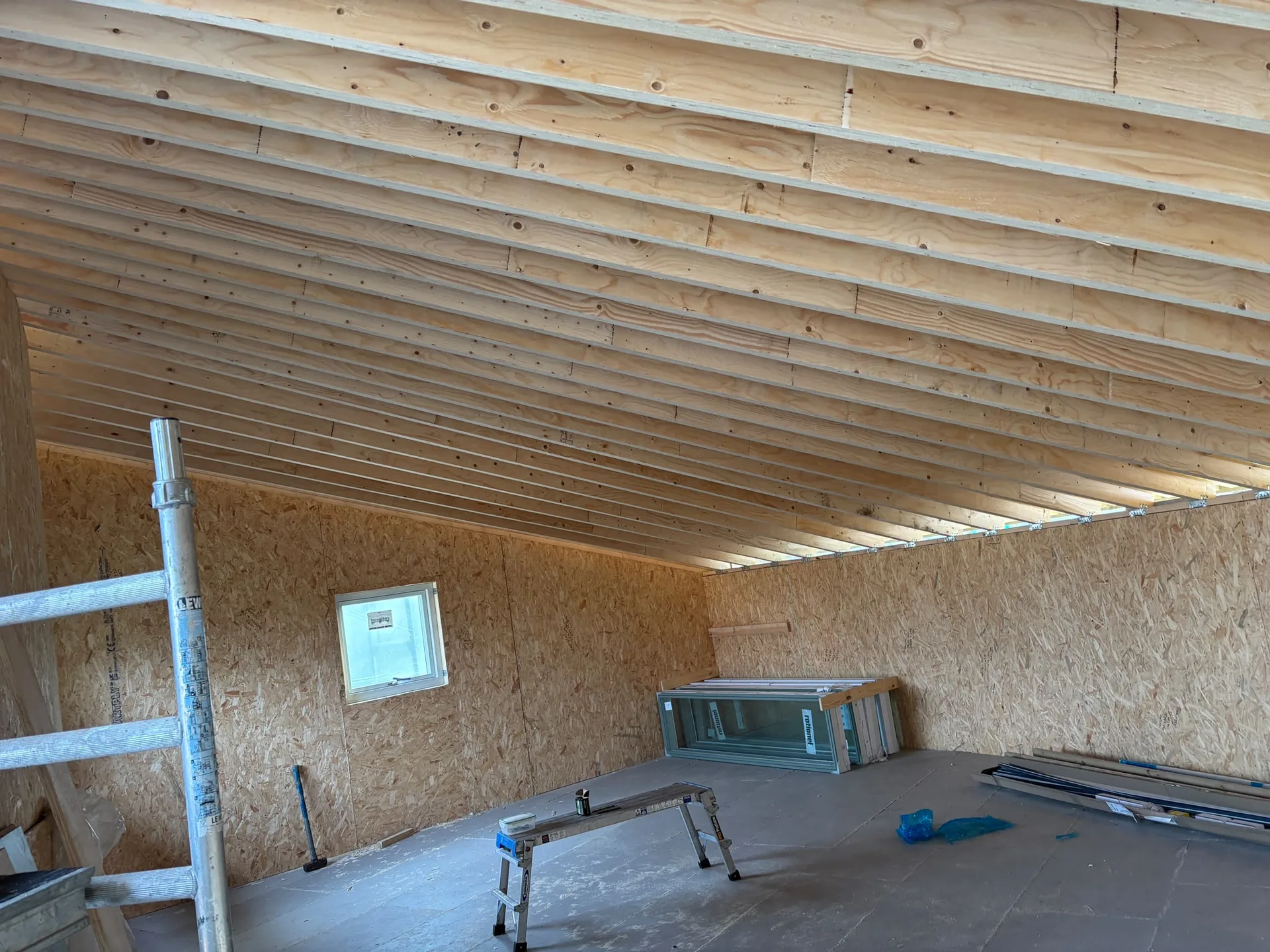 Interior structural framework with exposed wooden joists, OSB walls and construction in progress, Structural Works