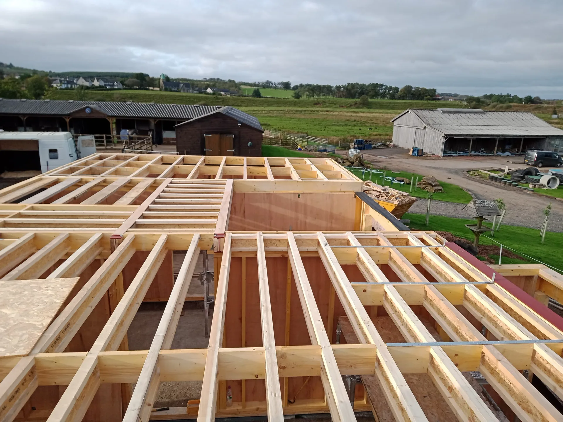 Wooden floor and joist framework under construction showing timber structural beams at new build project site