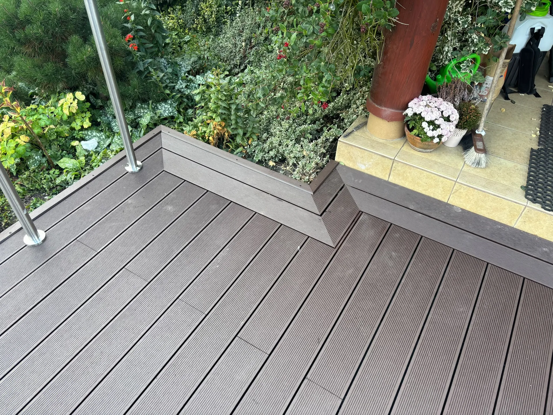 Professional timber decking in grey composite boards overlooking lush garden landscaping